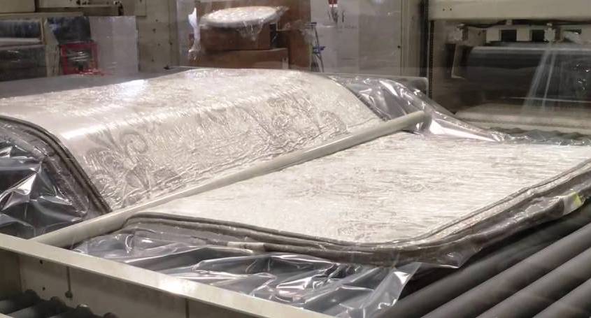 A compressed mattress before folding and rolling